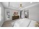 Bright main bedroom boasts neutral walls, carpet flooring, and doorway to a walk-in closet at 9120 Warm Springs Cir, Parrish, FL 34219