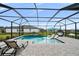 Enjoy this screened pool area with beautiful pavers, lounge chairs, and a view of the pond at 9120 Warm Springs Cir, Parrish, FL 34219