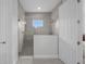 Tiled walk-in shower with clear glass enclosure and window at 9120 Warm Springs Cir, Parrish, FL 34219