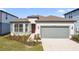 Beautiful one-story home with a well-manicured lawn, two-car garage, and neutral paint scheme at 20761 Balsam Hill Rd, Land O Lakes, FL 34638
