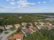 Aerial view of a residential neighborhood with lush landscaping and lake views at 5621 Rock Dove Dr, Sarasota, FL 34241
