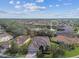 Aerial view of a residential neighborhood with lush landscaping and lake views at 5621 Rock Dove Dr, Sarasota, FL 34241