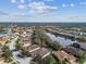 Aerial view of a residential neighborhood with lush landscaping and lake views at 5621 Rock Dove Dr, Sarasota, FL 34241
