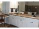 Bathroom vanity with double sinks, granite counters, and white cabinets at 5621 Rock Dove Dr, Sarasota, FL 34241