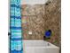 Bathroom with tile shower and blue striped curtain at 5621 Rock Dove Dr, Sarasota, FL 34241