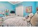 Cozy bedroom with beach theme, plush blanket, and white furnishings at 5621 Rock Dove Dr, Sarasota, FL 34241