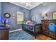 Blue themed bedroom with wooden furniture and fish themed rug at 5621 Rock Dove Dr, Sarasota, FL 34241