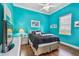 Blue bedroom with sleek hardwood flooring, neutral bedding and white dresser at 5621 Rock Dove Dr, Sarasota, FL 34241