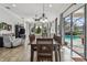 Inviting dining area with views of the pool and modern furnishings at 5621 Rock Dove Dr, Sarasota, FL 34241