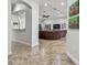 Open hallway leading into spacious living area with large leather sofa at 5621 Rock Dove Dr, Sarasota, FL 34241