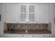 Kitchen wet bar with white cabinetry and countertop at 5621 Rock Dove Dr, Sarasota, FL 34241