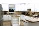 Bright kitchen features white cabinetry, granite countertops, and stainless steel appliances, blending style and functionality at 5621 Rock Dove Dr, Sarasota, FL 34241