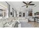 Spacious living room featuring large sofa, open layout, and tile flooring at 5621 Rock Dove Dr, Sarasota, FL 34241