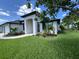 Exterior elevation showcasing lush lawn and landscaping and a white stucco facade at 7101 N Plum Tree, Punta Gorda, FL 33955