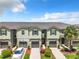 Aerial view of townhome community showcasing multiple units and parking at 11650 Cambium Crown Dr, Riverview, FL 33569