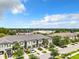 Aerial view of townhomes with a street and surrounding landscape at 11650 Cambium Crown Dr, Riverview, FL 33569