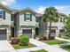 Townhome community featuring multiple two-story units and lush landscaping at 11650 Cambium Crown Dr, Riverview, FL 33569