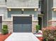 Attached garage with stone accents and landscaping at 11650 Cambium Crown Dr, Riverview, FL 33569