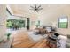 Relaxing main bedroom with hardwood floors, tray ceiling, ceiling fan, and sliding doors to lanai at 9276 Starry Night Ave, Sarasota, FL 34241