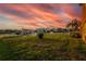 Large backyard with grass, sunset view, and canal access at 6404 Key Island Ave, Apollo Beach, FL 33572