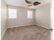 Spacious bedroom with neutral walls and carpet, ceiling fan, and two windows at 6404 Key Island Ave, Apollo Beach, FL 33572