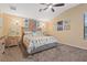 Bright bedroom with a tropical themed decor and a ceiling fan at 10918 Rain Lilly Pass, Land O Lakes, FL 34638