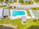 Community pool with surrounding patio and shuffleboard at 1305 Whitebridge Dr # A, Palm Harbor, FL 34684