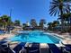 Resort-style pool with plenty of lounge chairs and palm trees at 617 Islebay Dr, Apollo Beach, FL 33572