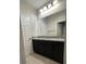 Bathroom boasts dark vanity and granite countertop at 12311 Terracina Chase Ct, Tampa, FL 33625