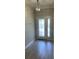 Bright entryway with wood-look floors and elegant light fixture at 12311 Terracina Chase Ct, Tampa, FL 33625