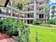 Exterior view of the building with lush landscaping at 3035 Countryside Blvd # 14B, Clearwater, FL 33761