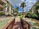 Walkway with bridge and pond features in a community at 3035 Countryside Blvd # 14B, Clearwater, FL 33761