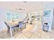 Bright dining area with light wood table, gray chairs, and kitchen view at 3035 Countryside Blvd # 14B, Clearwater, FL 33761