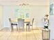 Bright dining area with light wood table and gray chairs at 3035 Countryside Blvd # 14B, Clearwater, FL 33761