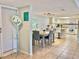 Bright dining area with light wood table, gray chairs, and kitchen view at 3035 Countryside Blvd # 14B, Clearwater, FL 33761