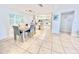 Bright dining area with light wood table, gray chairs, and kitchen view at 3035 Countryside Blvd # 14B, Clearwater, FL 33761