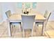 Light wood dining table with four gray chairs at 3035 Countryside Blvd # 14B, Clearwater, FL 33761