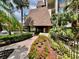 Community entrance with landscaped walkway and building access at 3035 Countryside Blvd # 14B, Clearwater, FL 33761