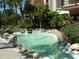 Small pond with a fountain and tropical landscaping at 3035 Countryside Blvd # 14B, Clearwater, FL 33761
