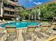 Relaxing community pool with lounge chairs for sunbathing at 3035 Countryside Blvd # 14B, Clearwater, FL 33761