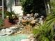Relaxing water feature with landscaping and pond at 3035 Countryside Blvd # 14B, Clearwater, FL 33761