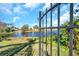 Black metal gate opening to a scenic lake view at 13339 Laraway Dr, Riverview, FL 33579