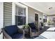 Inviting front porch with wicker chairs and potted plants at 1312 E 19Th Ave, Tampa, FL 33605