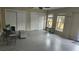Clean and organized garage with epoxy flooring, providing ample storage and workspace at 1513 Wharfside Dr # 1513, Tarpon Springs, FL 34689
