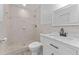 Updated bathroom with white vanity, marble countertop, and walk-in shower at 8402 Bedford Ln, Tampa, FL 33615