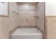 Bathroom with beige tile and built-in shower at 8402 Bedford Ln, Tampa, FL 33615