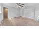 Well-lit bedroom with wood-look floors, double doors to closet and ensuite bathroom at 8402 Bedford Ln, Tampa, FL 33615