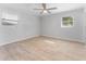 Spacious bedroom with light walls, wood-look floors and two windows at 8402 Bedford Ln, Tampa, FL 33615