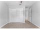 Simple bedroom with tile floors and mirrored closet doors at 8402 Bedford Ln, Tampa, FL 33615