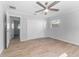 Bright bedroom with tile flooring, ceiling fan, and double door closet at 8402 Bedford Ln, Tampa, FL 33615